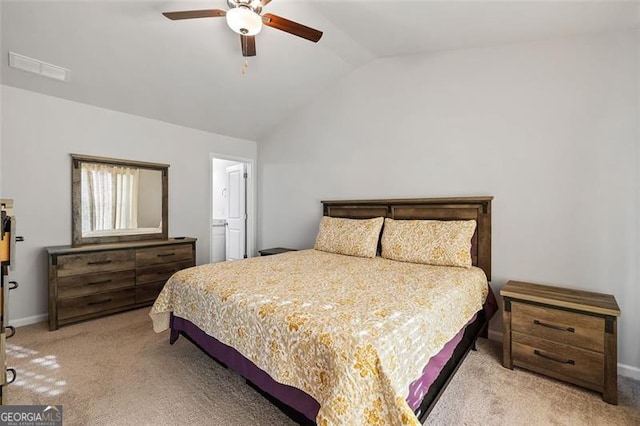 bedroom with vaulted ceiling, light colored carpet, and ceiling fan