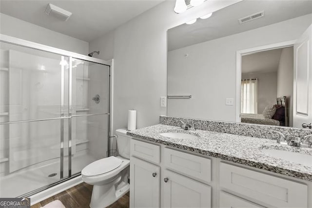 bathroom with walk in shower, wood-type flooring, toilet, and vanity