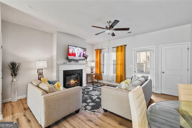 living room featuring ceiling fan and light wood-type flooring