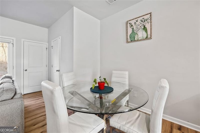 dining area with hardwood / wood-style floors