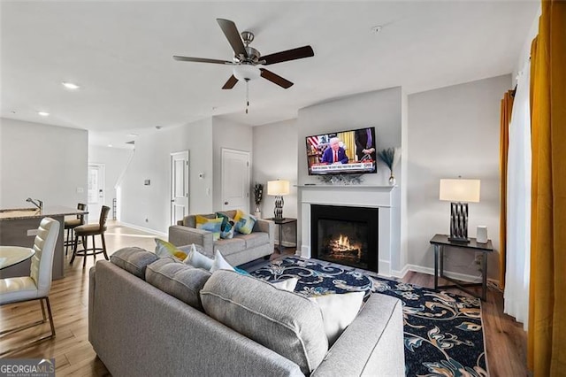 living room with hardwood / wood-style flooring and ceiling fan