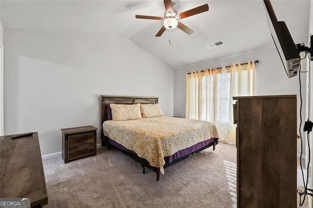 carpeted bedroom with ceiling fan and vaulted ceiling