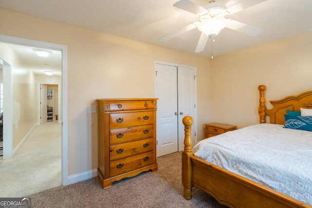 carpeted bedroom featuring ceiling fan and a closet