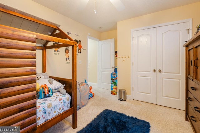 carpeted bedroom featuring a closet and ceiling fan