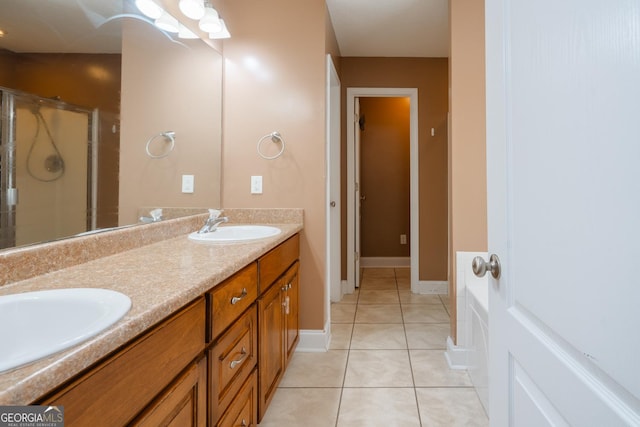 bathroom featuring a shower with door, vanity, and tile patterned floors