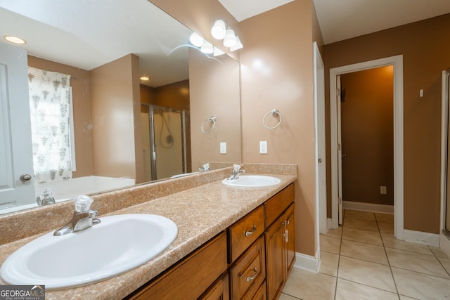 bathroom featuring tile patterned floors, an enclosed shower, and vanity