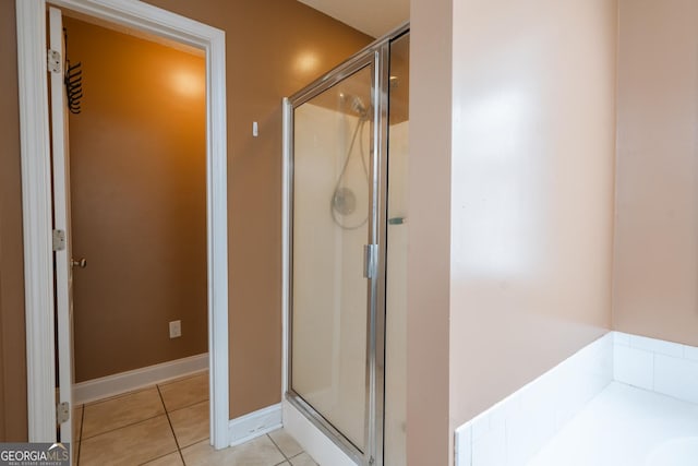 bathroom with tile patterned flooring and an enclosed shower