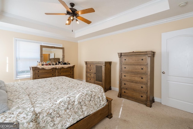 bedroom with a raised ceiling, ornamental molding, light carpet, and ceiling fan