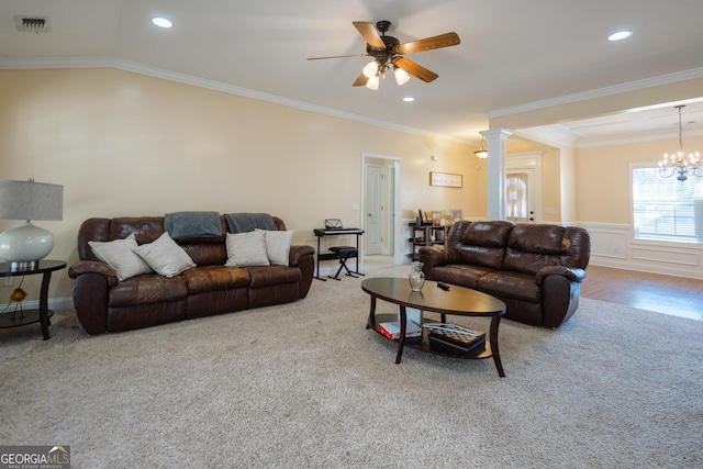 carpeted living room with ceiling fan with notable chandelier, vaulted ceiling, ornamental molding, and decorative columns