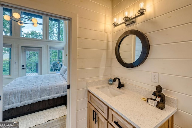 bathroom featuring vanity and wood walls