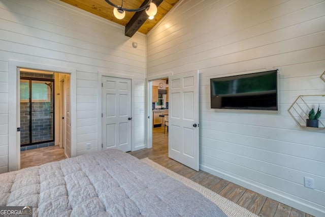 unfurnished bedroom featuring wood ceiling, wooden walls, high vaulted ceiling, and light wood-type flooring