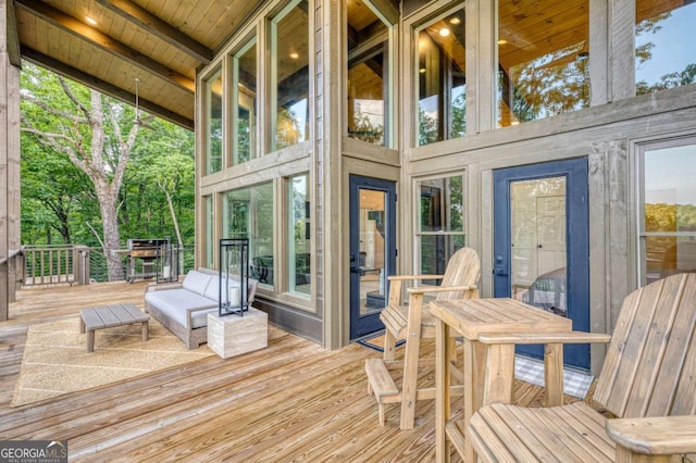 sunroom featuring wood ceiling and beam ceiling