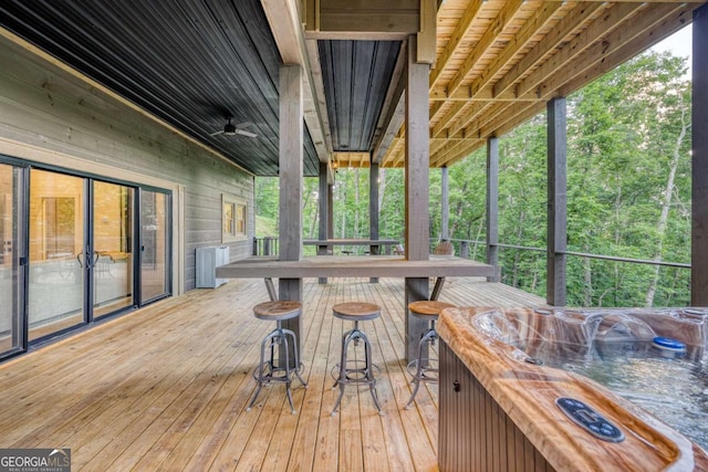 wooden deck featuring a hot tub