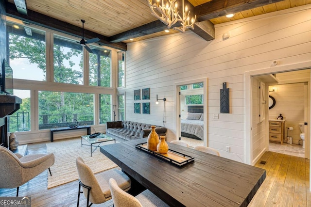 living room featuring beam ceiling, wooden ceiling, and light hardwood / wood-style floors