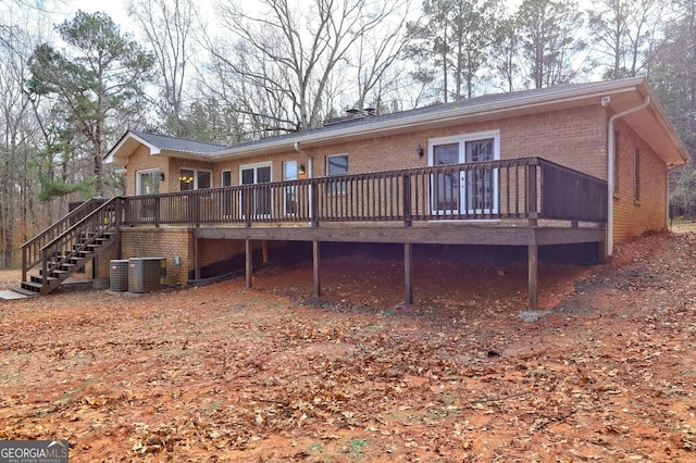 back of house featuring a wooden deck and central air condition unit