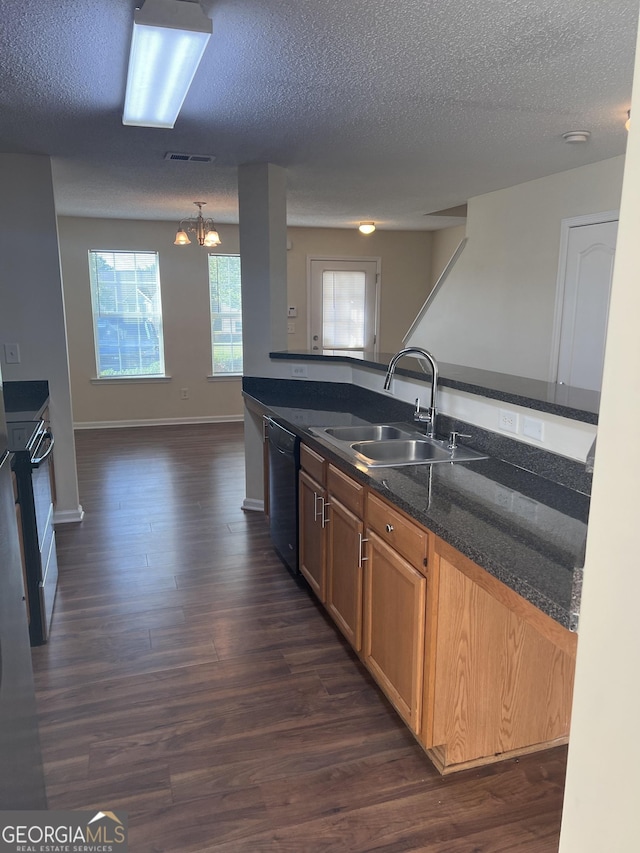 kitchen with sink, dark wood-type flooring, hanging light fixtures, and black dishwasher