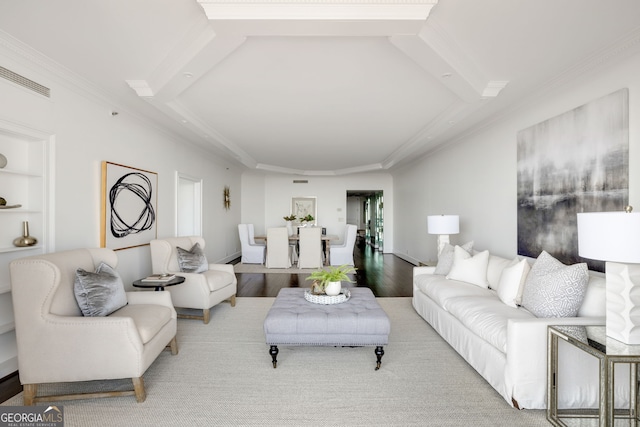 living room with built in features, crown molding, and wood finished floors