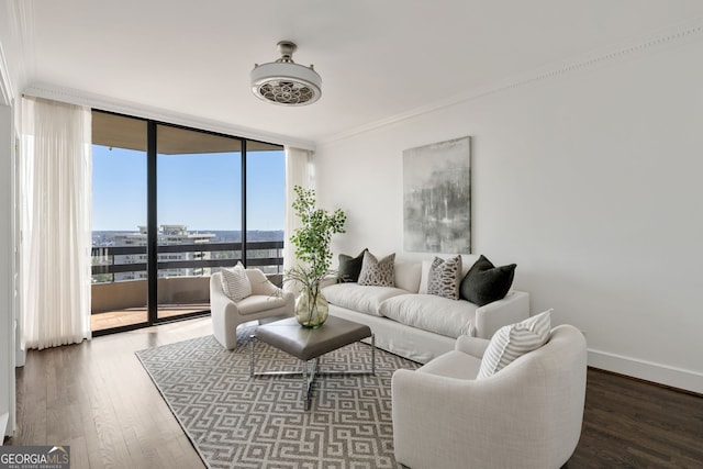 living room with baseboards, floor to ceiling windows, crown molding, and wood finished floors