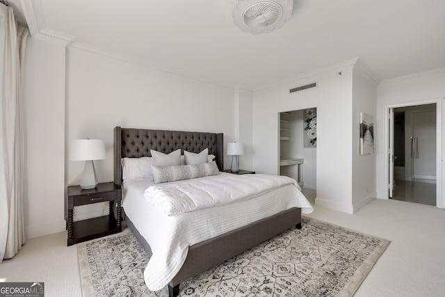 carpeted bedroom featuring baseboards, visible vents, crown molding, and ensuite bathroom