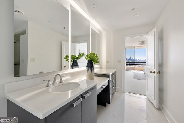 bathroom featuring tile patterned flooring, vanity, and baseboards