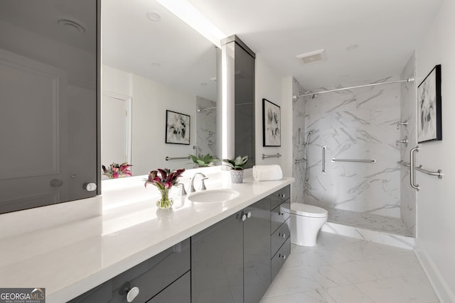 bathroom with a marble finish shower, marble finish floor, vanity, and toilet