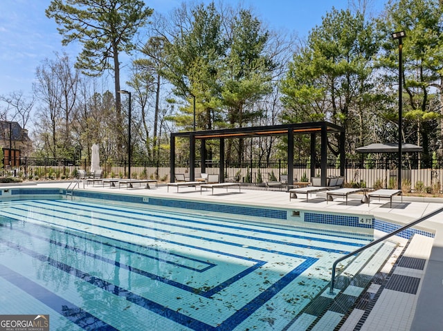 community pool with fence and a patio