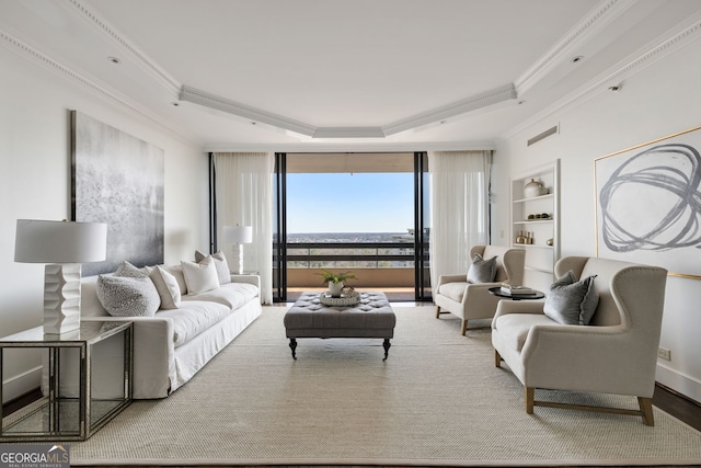 living room featuring built in shelves, a raised ceiling, crown molding, and baseboards