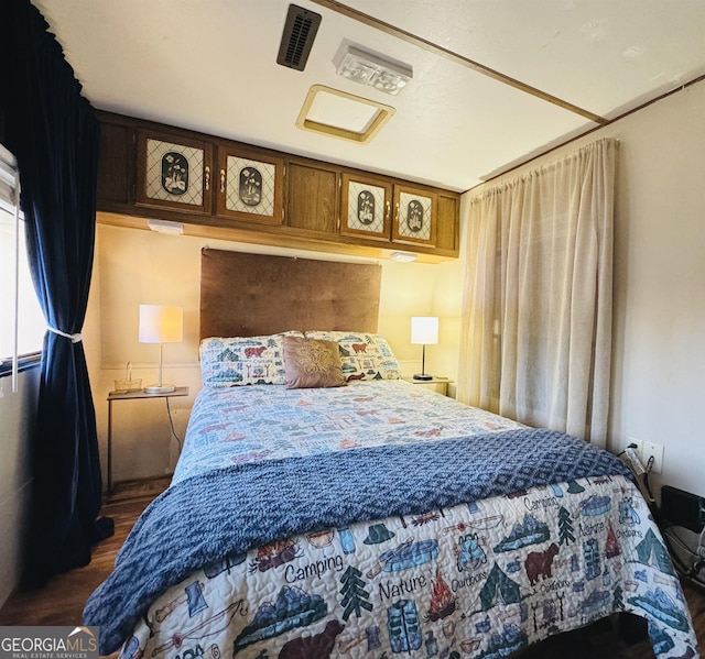 bedroom featuring dark hardwood / wood-style flooring