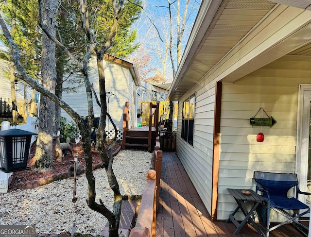 view of side of home with a wooden deck