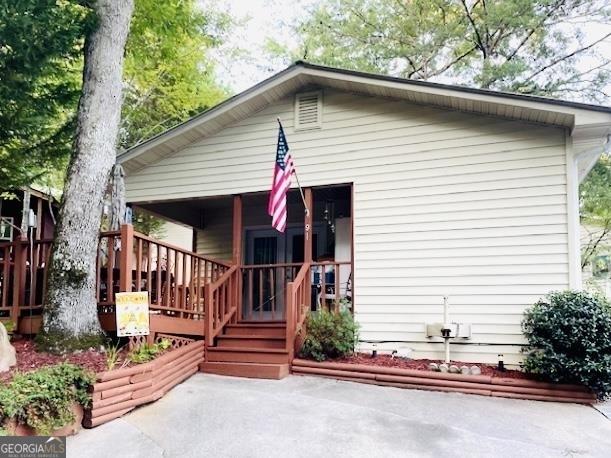 back of house featuring a porch