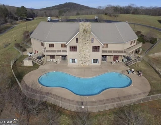 view of pool with a mountain view and a patio area