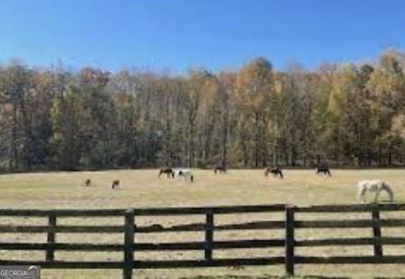 view of gate with a rural view