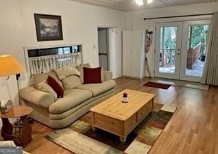 living room with french doors and light hardwood / wood-style floors