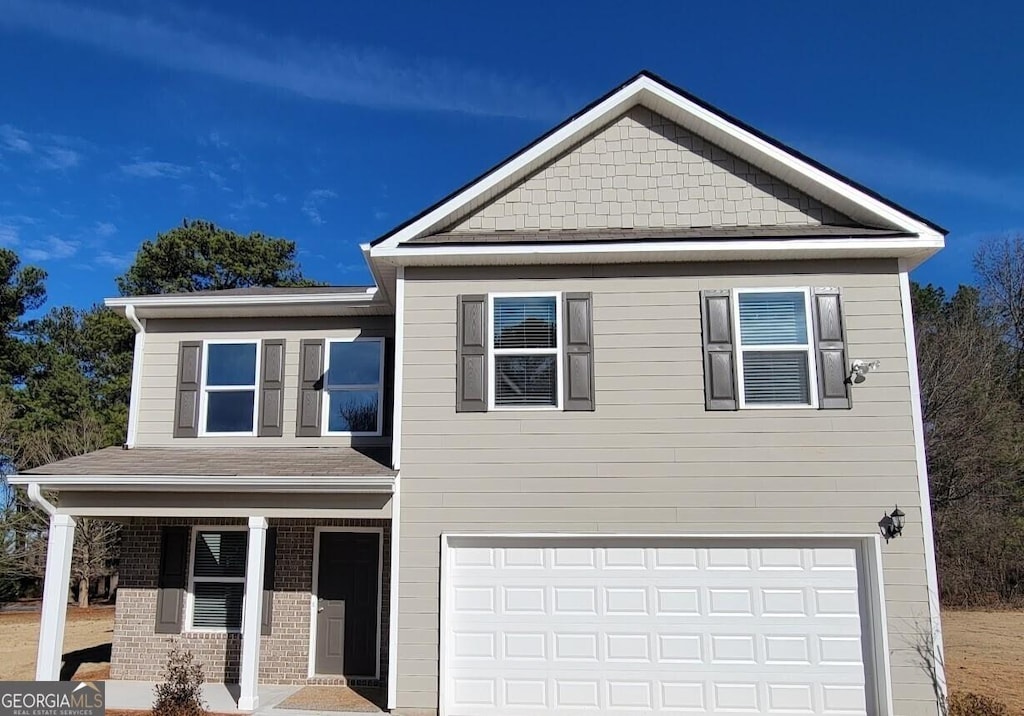 view of front of home featuring a porch and a garage