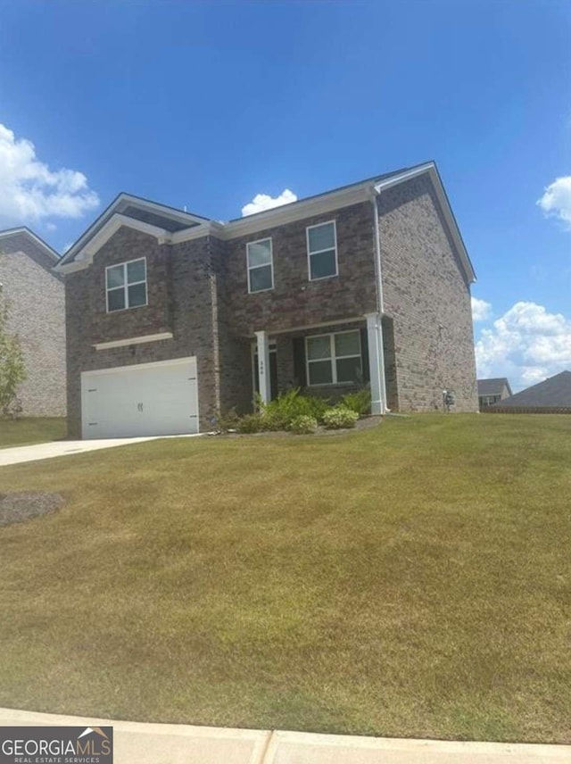 view of front of home featuring a garage and a front yard