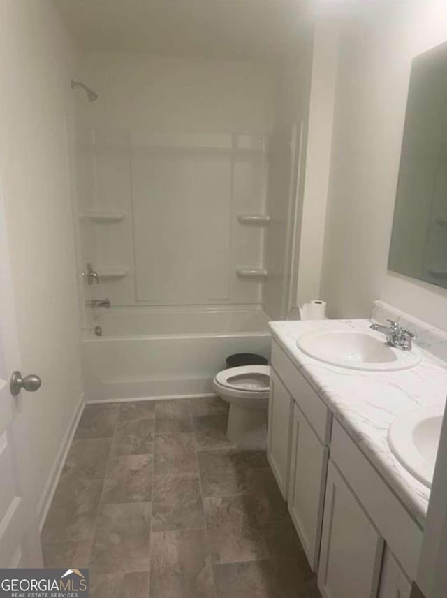 full bathroom featuring vanity, bathtub / shower combination, and toilet