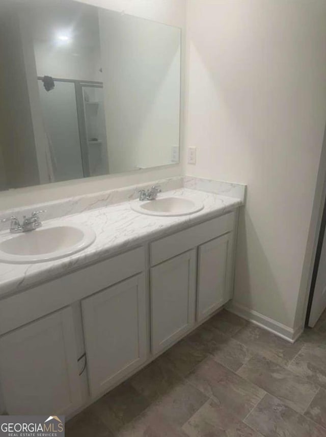 bathroom with vanity and walk in shower