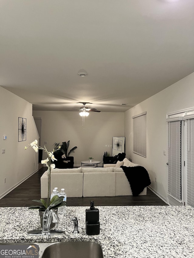 living room with dark wood-type flooring and ceiling fan