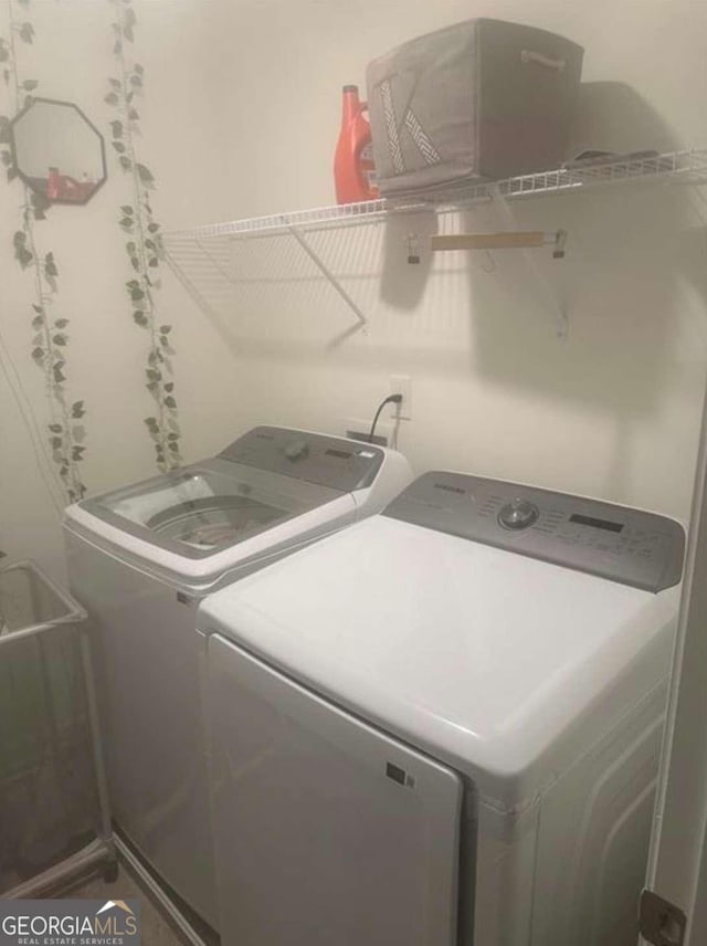 laundry area featuring washing machine and clothes dryer