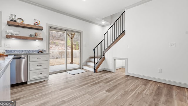 interior space featuring dishwasher, white cabinets, crown molding, light stone countertops, and light hardwood / wood-style flooring