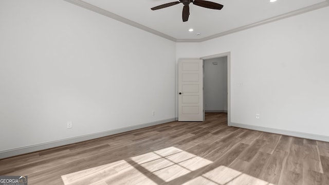 empty room featuring ornamental molding, ceiling fan, and light wood-type flooring