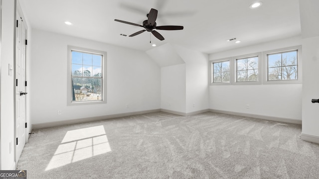 additional living space featuring light carpet and ceiling fan