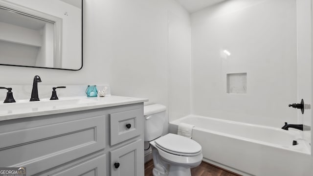 full bathroom featuring hardwood / wood-style flooring, vanity, toilet, and tub / shower combination