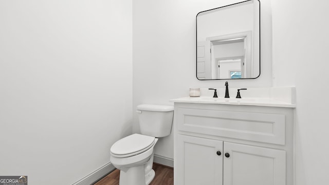 bathroom featuring vanity, toilet, and wood-type flooring