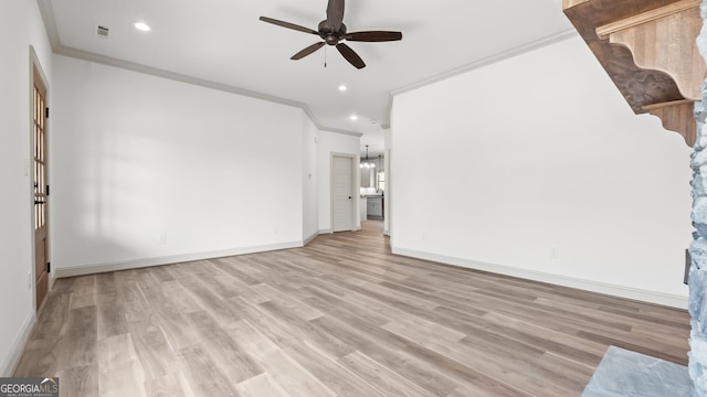 unfurnished living room featuring ceiling fan, ornamental molding, and light hardwood / wood-style flooring