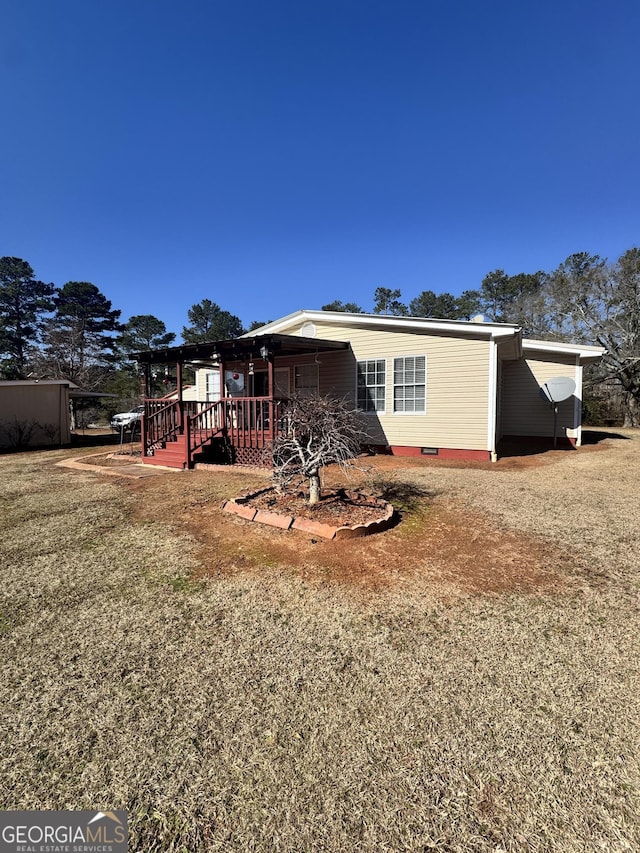 rear view of house featuring a yard