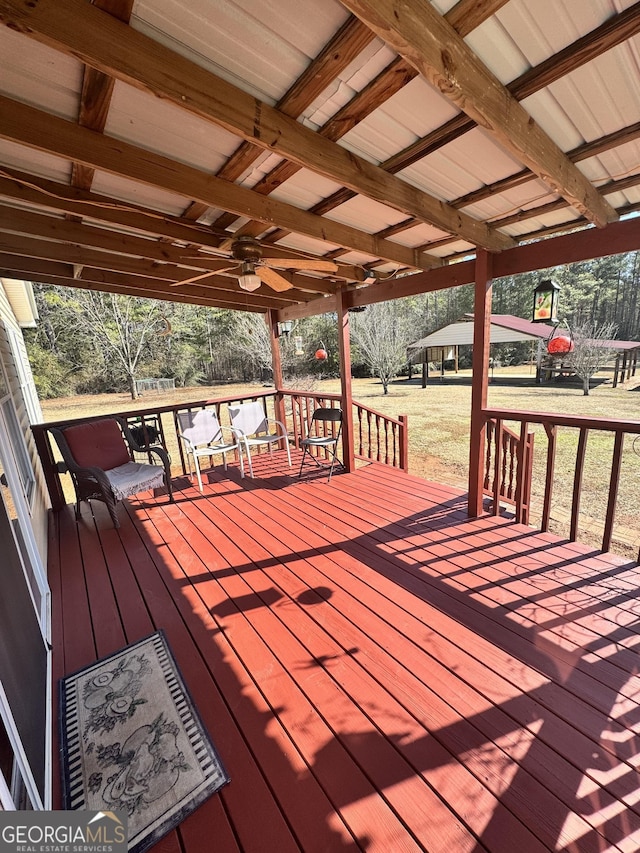 wooden terrace with a lawn