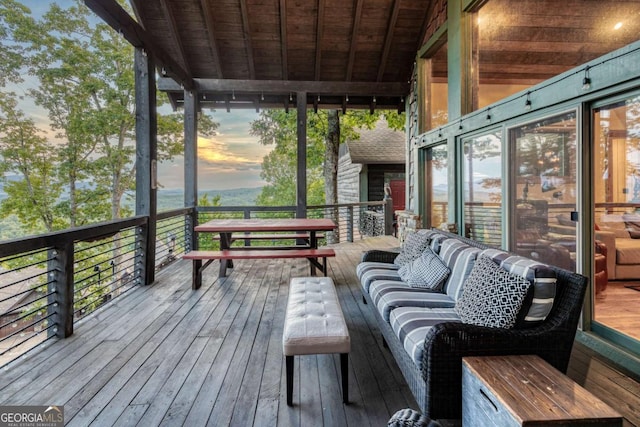 deck at dusk featuring an outdoor living space