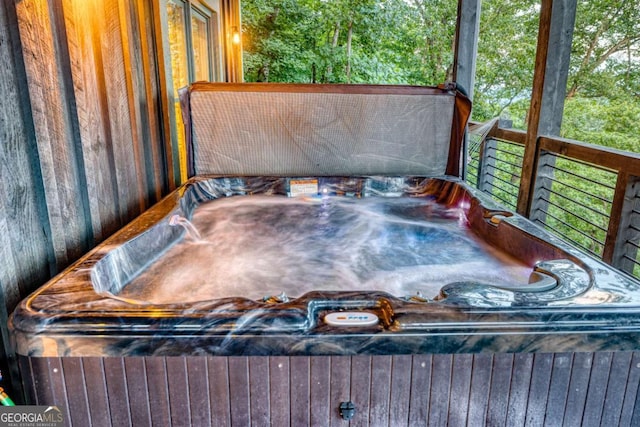 wooden deck featuring a jacuzzi