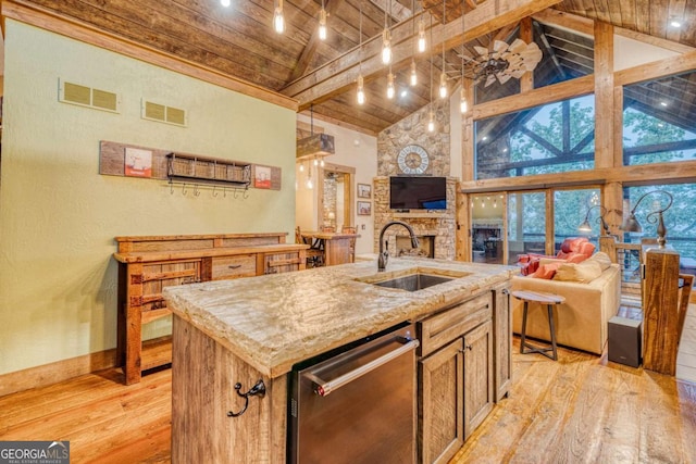 kitchen featuring dishwasher, sink, a kitchen island with sink, light hardwood / wood-style floors, and wooden ceiling